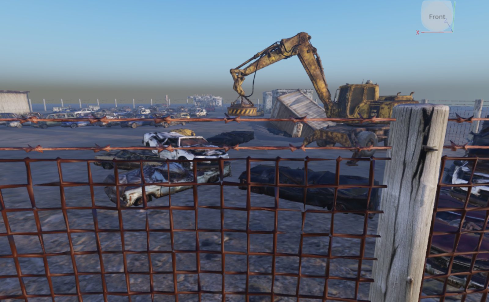 Roblox Studio editor view of the scrapyard — the magnet crane and shipping container seen past a barbed-wire fence, wrecked cars scattered